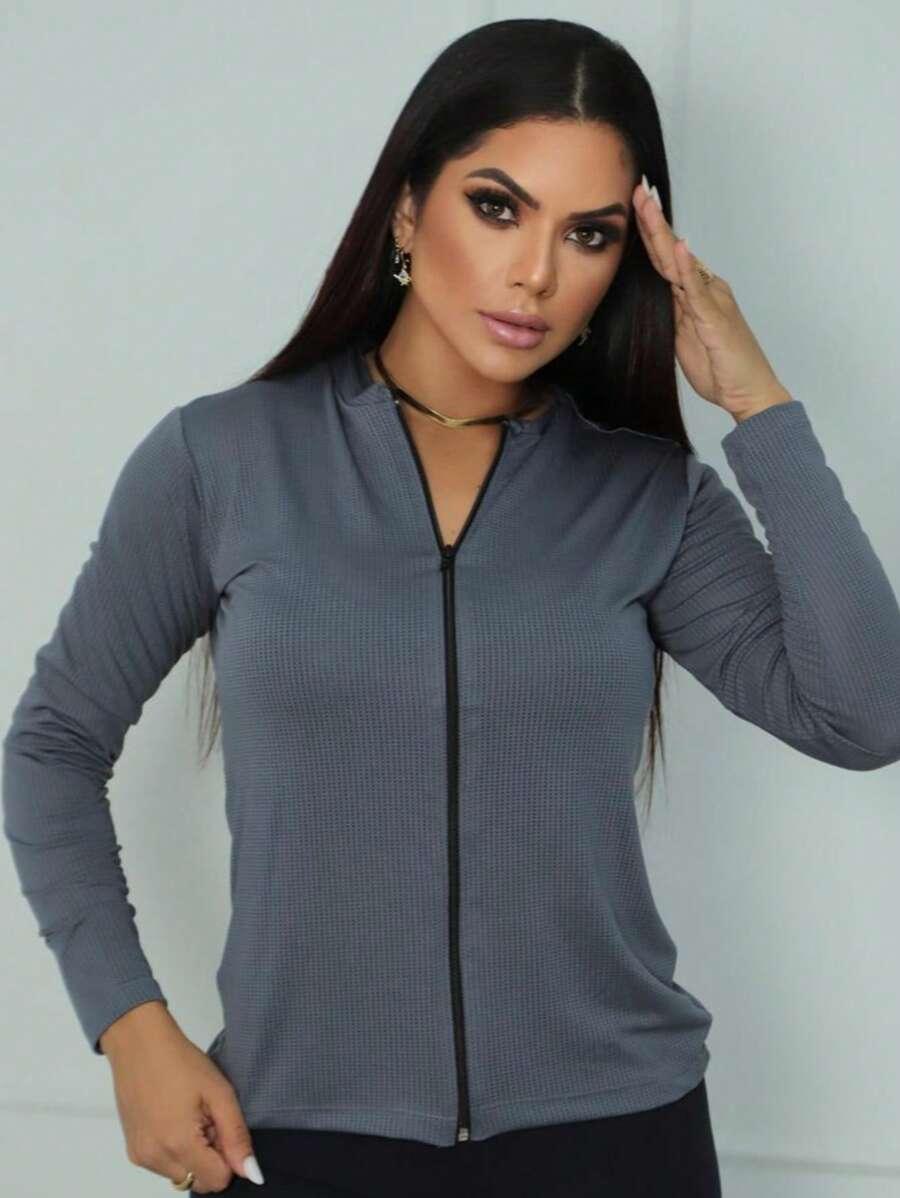 mulher com casaco cinza com zíper frente em fundo branco fosco